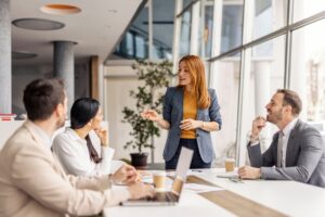 Female manager standing up and briefing her team members